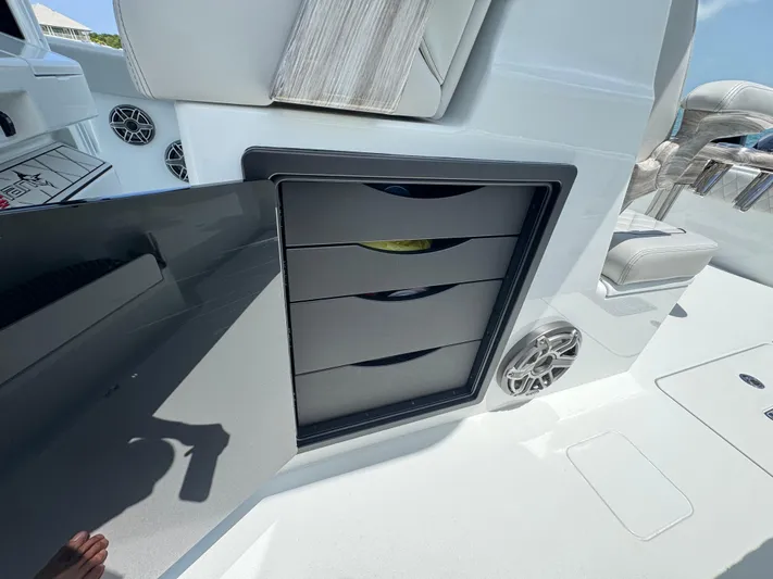  Yacht Photos Pics Open storage compartment on Freeman 38 boat, featuring multiple drawers and speaker, 2025 model.