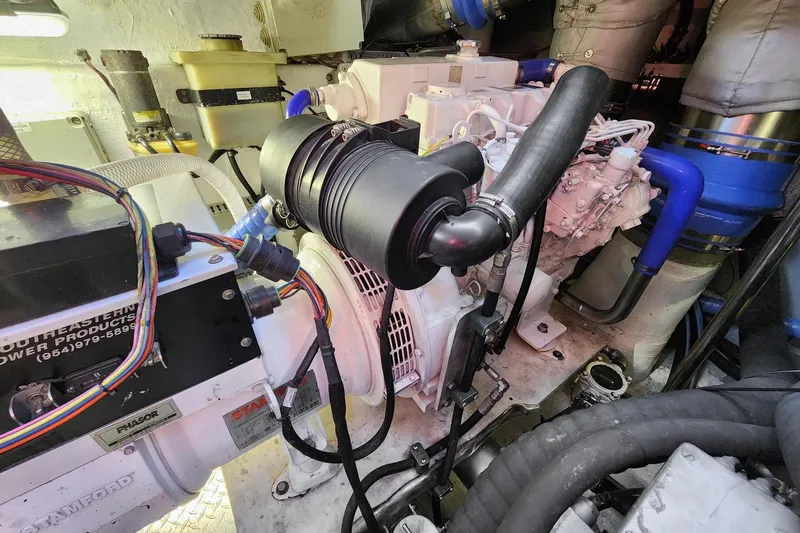 Alchemy Yacht Photos Pics Engine room of a 2003 Baia PANTHER 80 yacht, showcasing mechanical components and wiring.