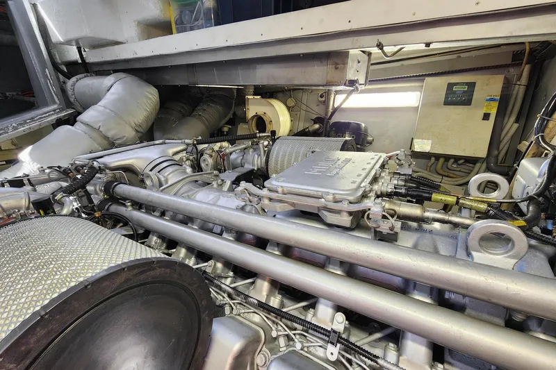 Alchemy Yacht Photos Pics Engine room of a 2003 Baia PANTHER 80 yacht, showcasing mechanical components and systems.