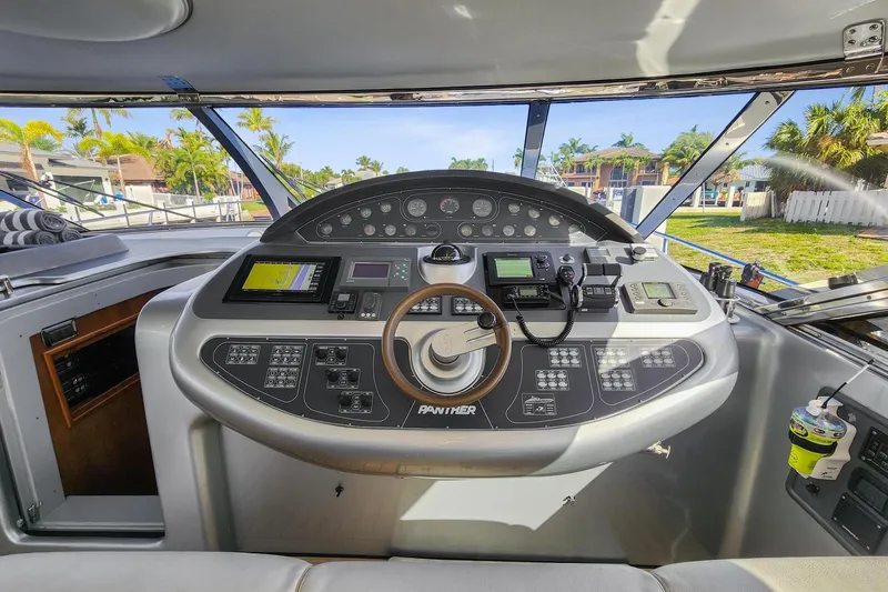 Alchemy Yacht Photos Pics Cockpit of 2003 Baia PANTHER 80 yacht with advanced navigation controls and steering wheel.