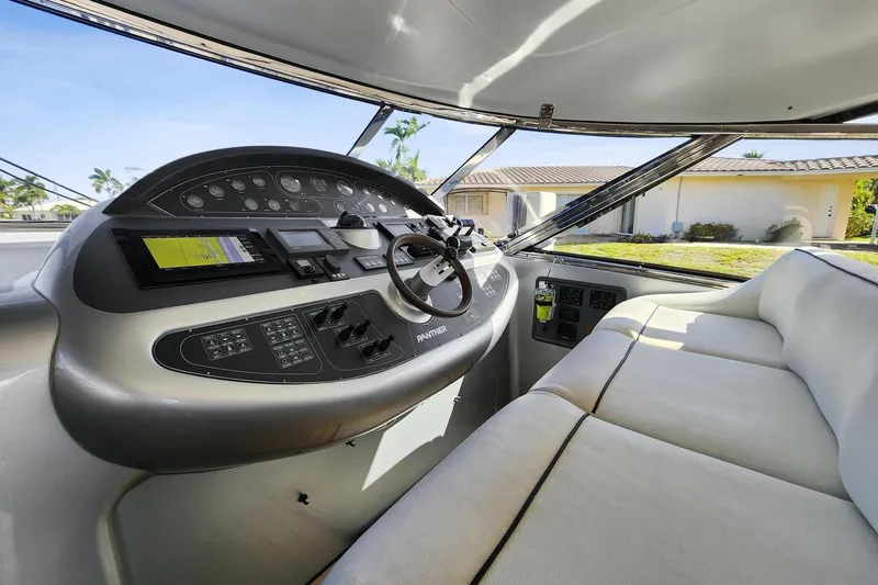 Alchemy Yacht Photos Pics 2003 Baia PANTHER 80 yacht cockpit with modern controls and plush seating.