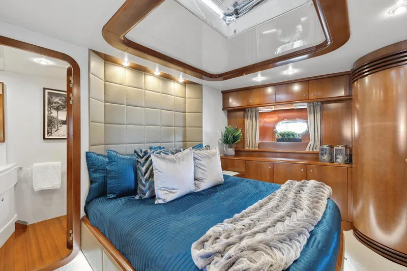 Alchemy Yacht Photos Pics Luxurious cabin interior of 2003 Baia PANTHER 80 yacht with elegant bedding and wood finishes.