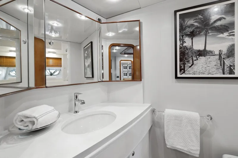 Alchemy Yacht Photos Pics Luxurious bathroom in 2003 Baia PANTHER 80 yacht with elegant decor and framed artwork.