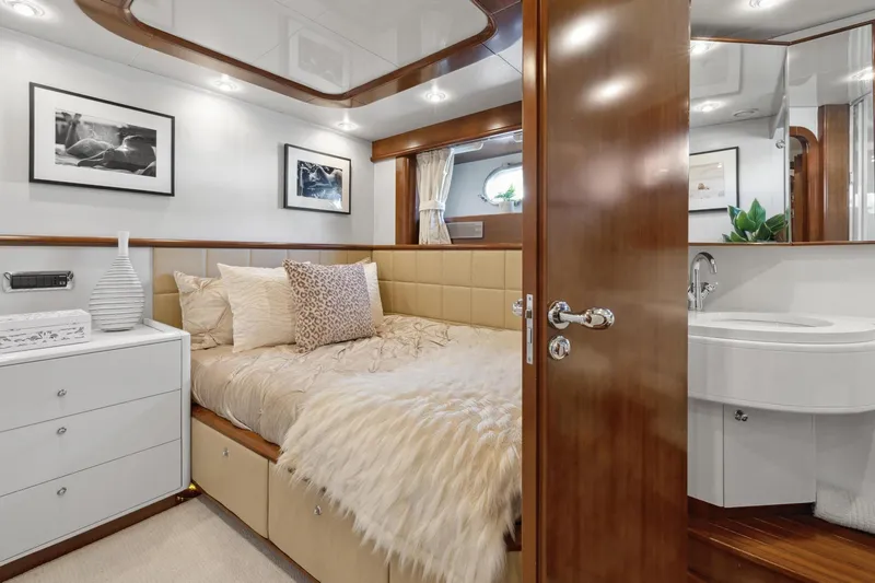 Alchemy Yacht Photos Pics Luxurious cabin interior of 2003 Baia PANTHER 80 yacht with elegant decor and cozy bedding.