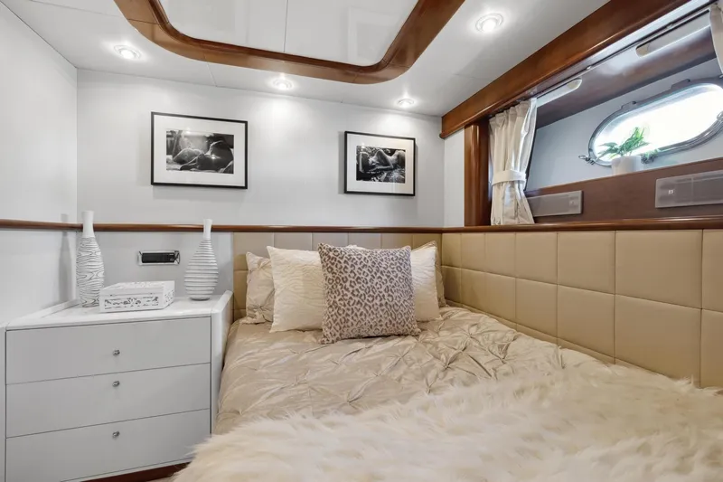 Alchemy Yacht Photos Pics Luxurious cabin interior of 2003 Baia PANTHER 80 yacht with elegant decor and cozy bedding.