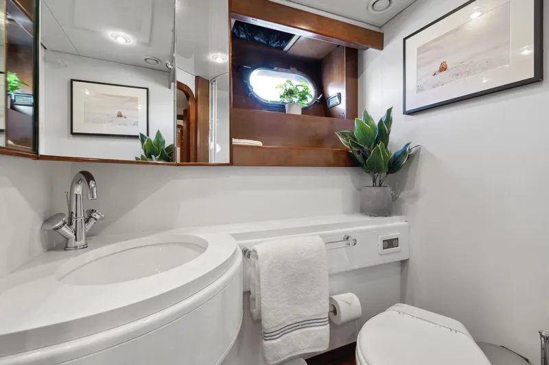 Alchemy Yacht Photos Pics Luxurious bathroom in 2003 Baia PANTHER 80 yacht with modern fixtures and decor.
