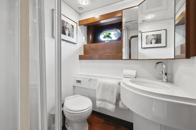 Alchemy Yacht Photos Pics Luxurious bathroom in 2003 Baia PANTHER 80 yacht with modern fixtures and elegant decor.