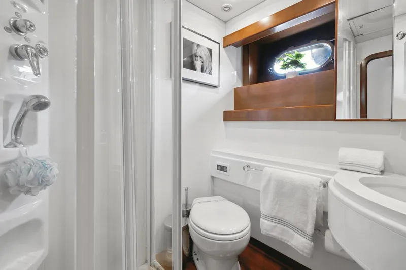 Alchemy Yacht Photos Pics Luxurious bathroom in 2003 Baia PANTHER 80 yacht with modern fixtures and elegant design.