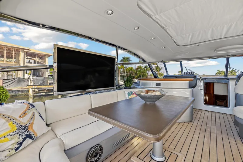 Alchemy Yacht Photos Pics Luxurious 2003 Baia PANTHER 80 yacht interior with elegant seating and large TV.