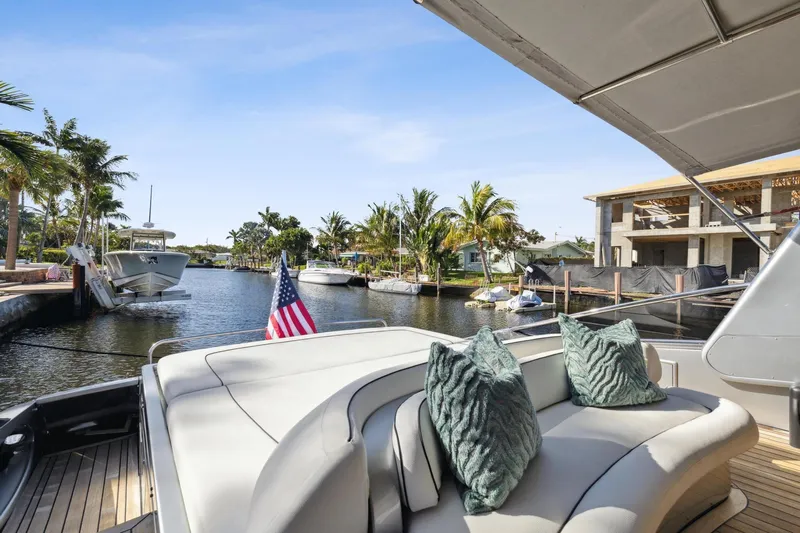 Alchemy Yacht Photos Pics Luxurious 2003 Baia PANTHER 80 yacht docked in a scenic canal setting.