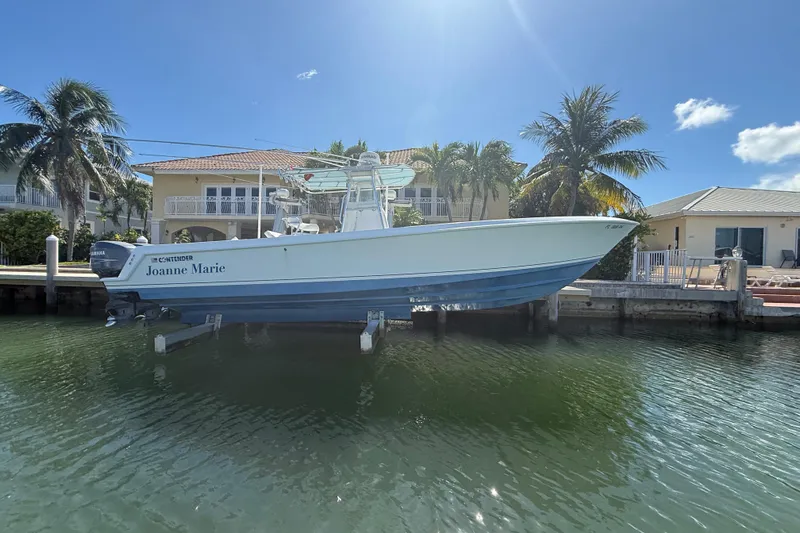 Yacht Photos Pics 2008 Contender 33 Tournament boat docked near waterfront homes, sunny day.