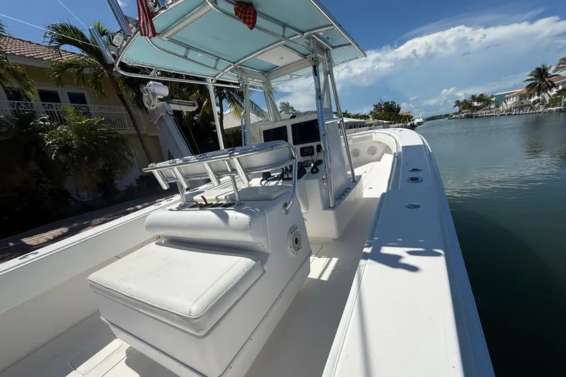  Yacht Photos Pics 2008 Contender 33 Tournament boat docked by a scenic waterfront.