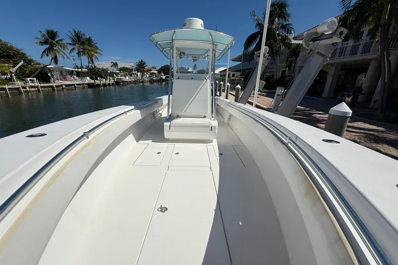 Yacht Photos Pics 2008 Contender 33 Tournament boat docked by palm trees and waterfront homes.