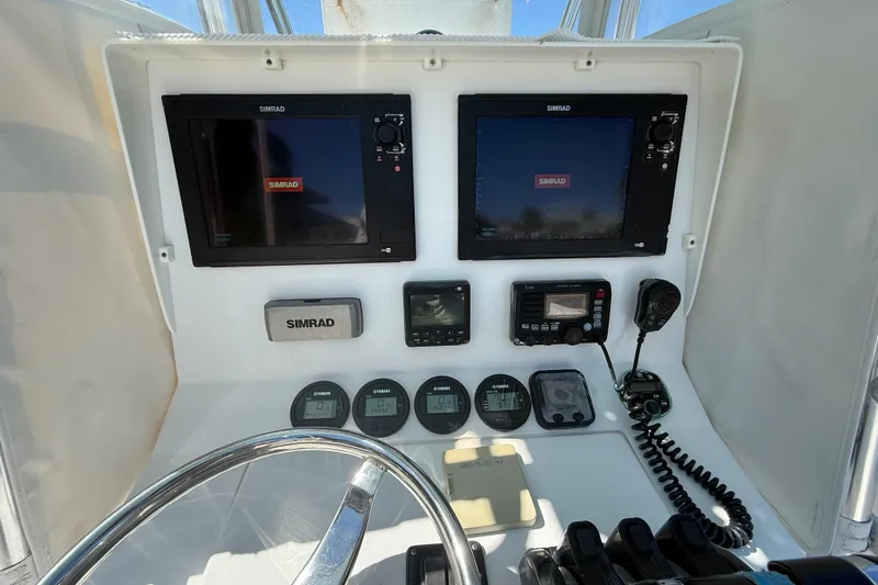  Yacht Photos Pics 2008 Contender 33 Tournament boat dashboard with Simrad navigation equipment and controls.