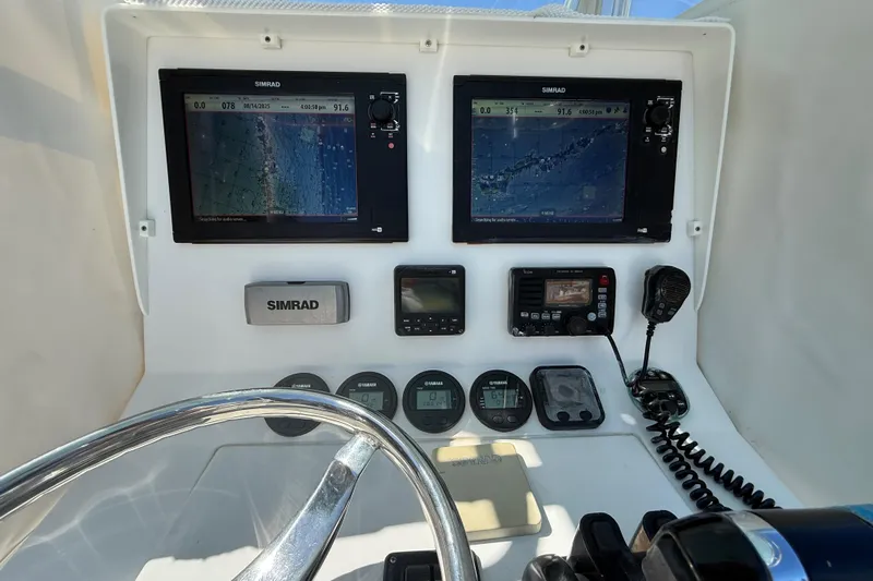  Yacht Photos Pics 2008 Contender 33 Tournament boat dashboard with Simrad navigation displays and controls.