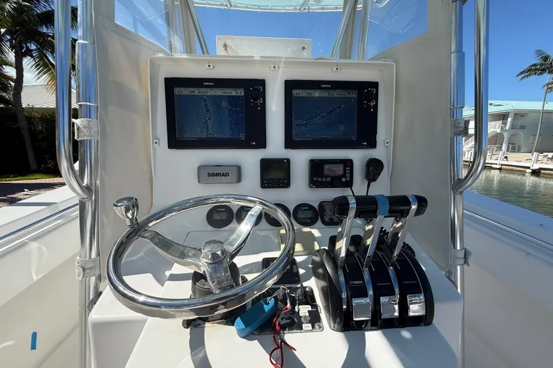  Yacht Photos Pics 2008 Contender 33 Tournament boat dashboard with steering wheel, controls, and navigation screens.