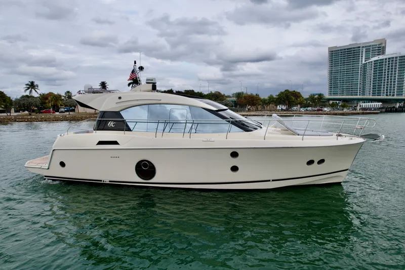  Yacht Photos Pics 2017 Beneteau Monte Carlo 5S yacht on water, cityscape background.