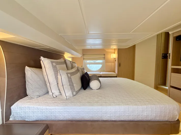  Yacht Photos Pics Luxurious bedroom interior of 2017 Beneteau Monte Carlo 5S yacht, featuring elegant bedding and modern design.