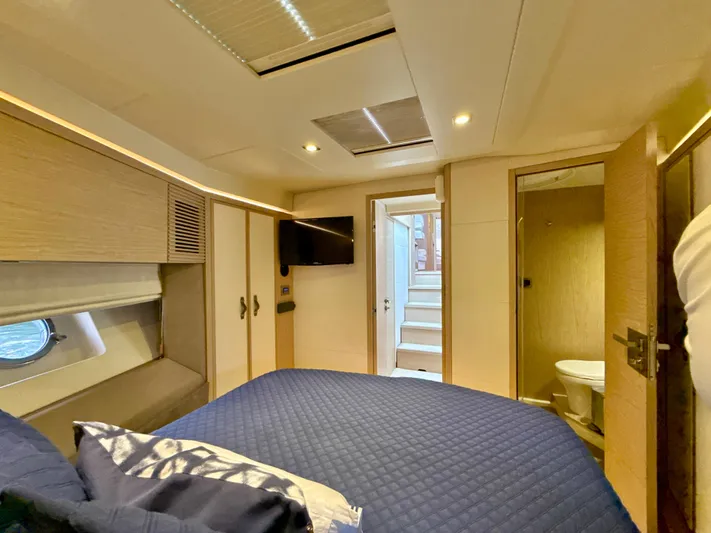  Yacht Photos Pics Luxurious cabin interior of 2017 Beneteau Monte Carlo 5S yacht, featuring a cozy bed and modern amenities.