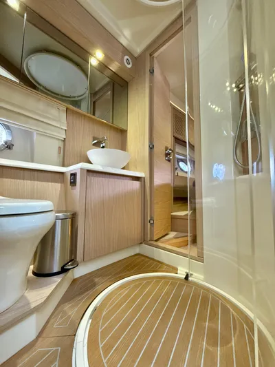  Yacht Photos Pics Luxurious bathroom in 2017 Beneteau Monte Carlo 5S yacht with modern fixtures and wood accents.