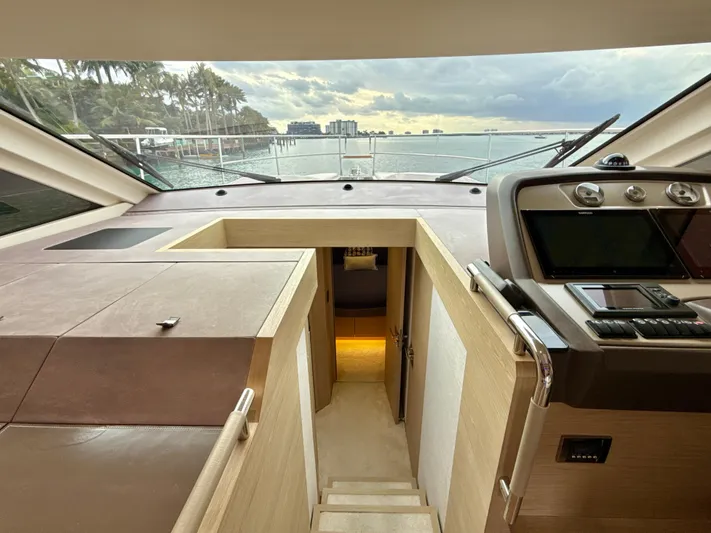  Yacht Photos Pics Interior view of 2017 Beneteau Monte Carlo 5S yacht, featuring helm and cabin entrance.