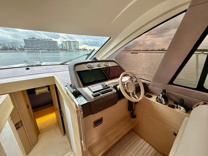  Yacht Photos Pics 2017 Beneteau Monte Carlo 5S yacht helm with modern controls and waterfront view.