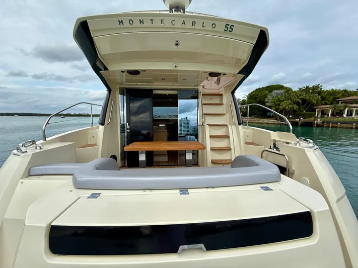  Yacht Photos Pics 2017 Beneteau Monte Carlo 5S yacht, rear view, docked with open deck and seating area.
