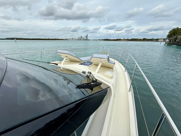  Yacht Photos Pics 2017 Beneteau Monte Carlo 5S yacht on calm waters, featuring sleek design and sun loungers.