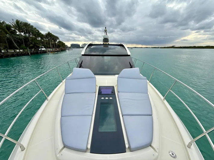  Yacht Photos Pics 2017 Beneteau Monte Carlo 5S yacht with sun loungers on turquoise water under cloudy sky.