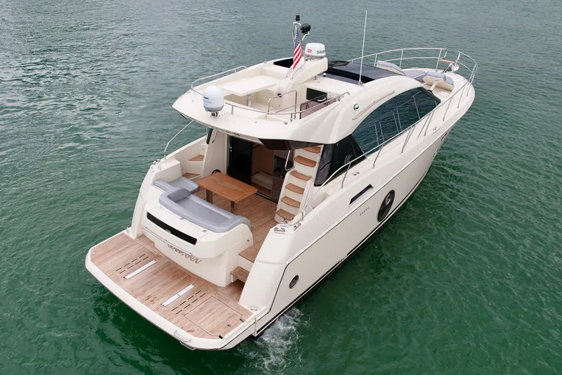  Yacht Photos Pics 2017 Beneteau Monte Carlo 5S yacht cruising on calm waters, rear view.