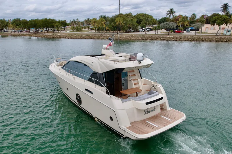  Yacht Photos Pics 2017 Beneteau Monte Carlo 5S yacht cruising in calm waters, rear view.