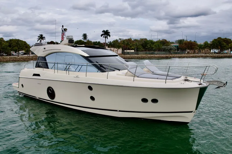  Yacht Photos Pics 2017 Beneteau Monte Carlo 5S yacht on calm water, cloudy sky backdrop.