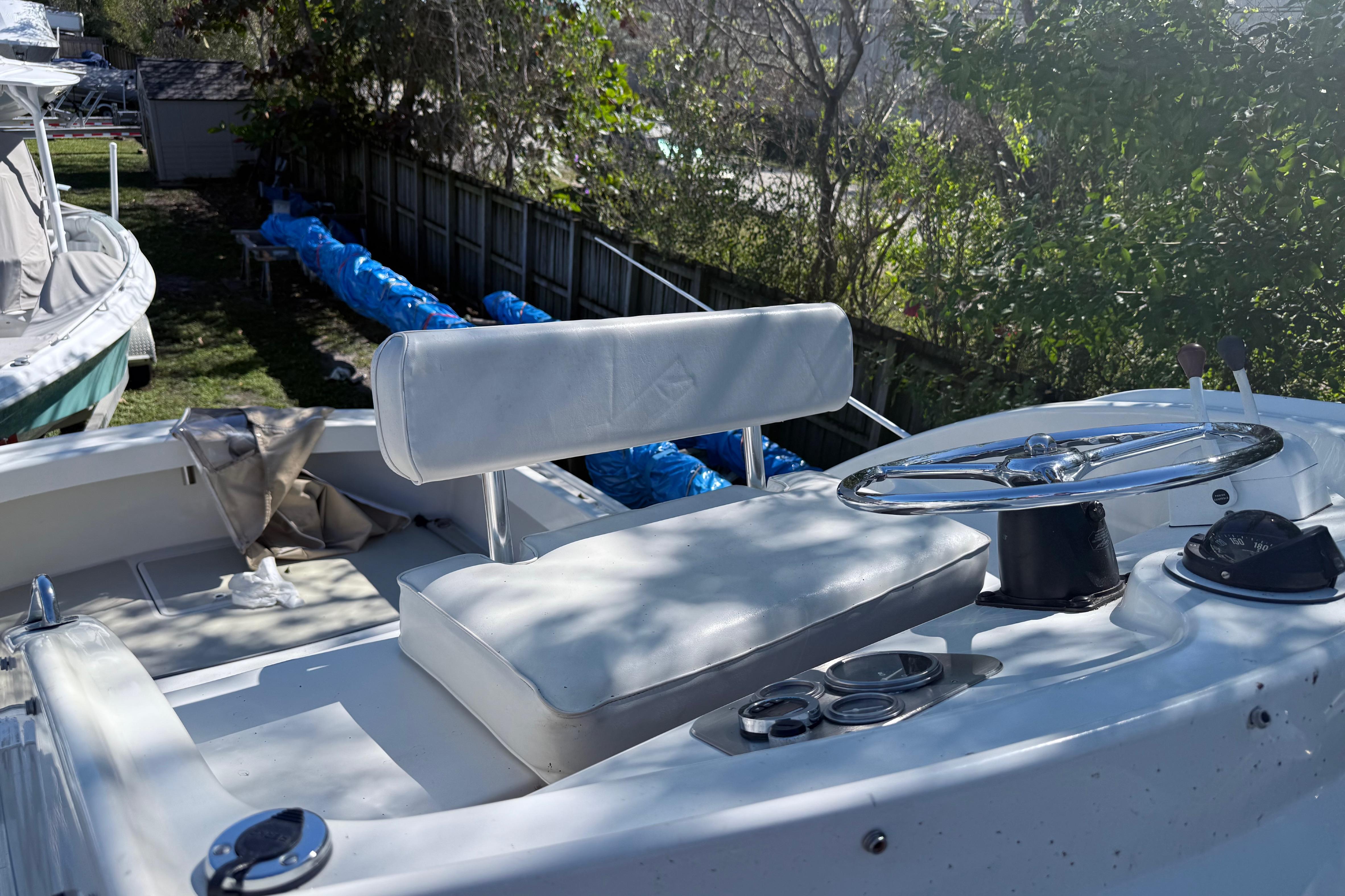 1969 Custom Alglas Saint John 25 ft. Sportfisher boat interior with steering wheel and seating.