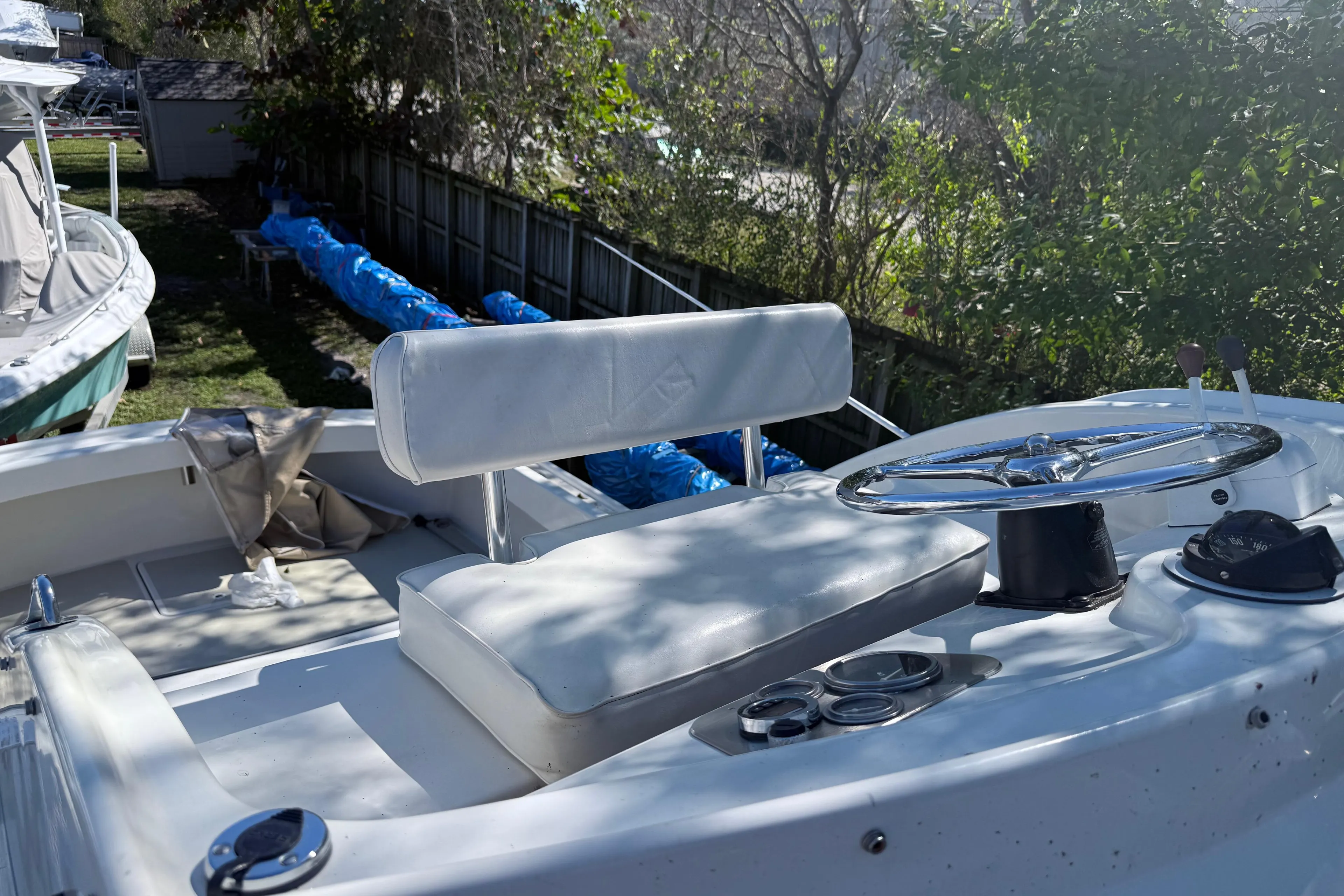 1969 Custom Alglas Saint John 25 ft. Sportfisher boat interior with steering wheel and seating.