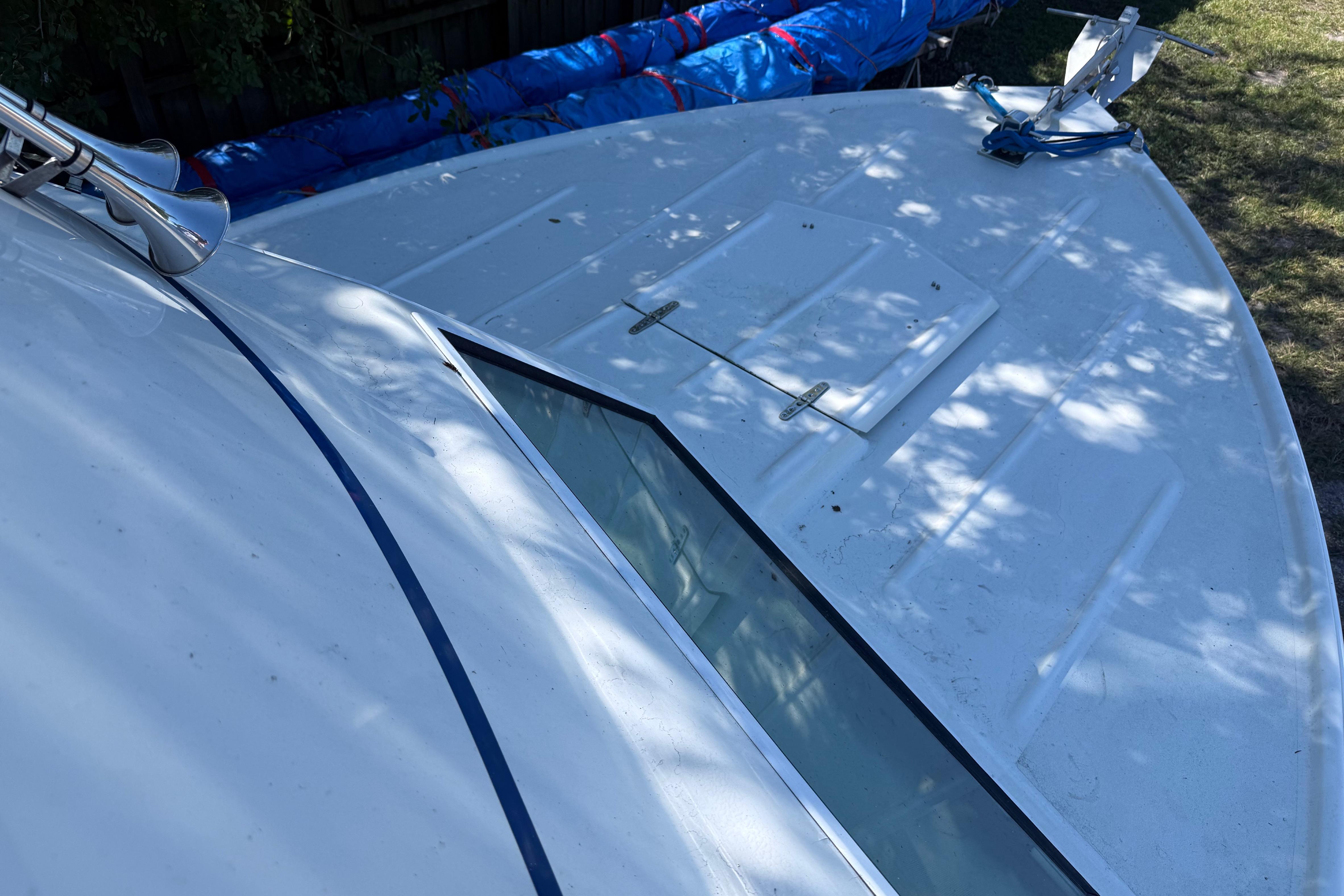 1969 Custom Alglas Saint John 25 ft. Sportfisher boat deck with hatch and horn.