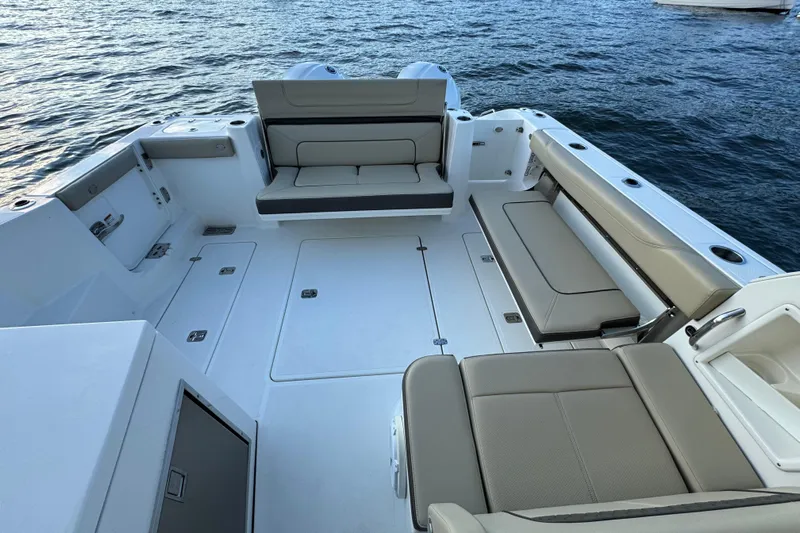  Yacht Photos Pics 2021 Pursuit DC 326 Dual Console boat interior with spacious seating and ocean backdrop.