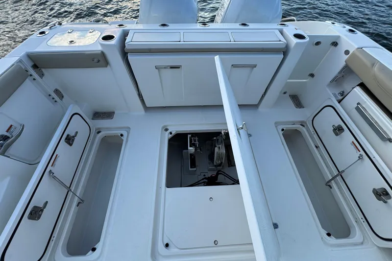  Yacht Photos Pics 2021 Pursuit DC 326 Dual Console boat interior with open storage compartments.