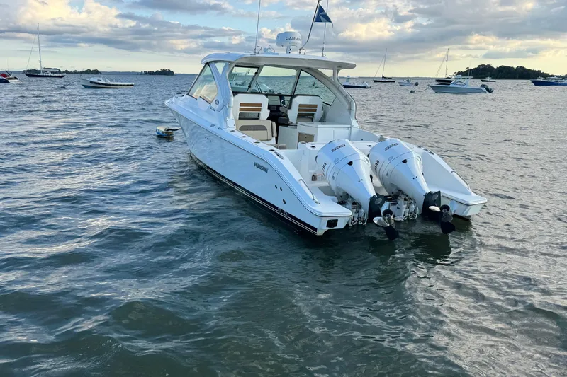  Yacht Photos Pics 2021 Pursuit DC 326 Dual Console boat on calm water, featuring twin engines.
