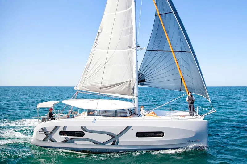  Yacht Photos Pics Manufacturer Provided Image: 2026 Excess 11 catamaran sailing on open sea with full sails.