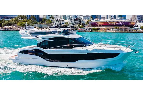  Yacht Photos Pics Manufacturer Provided Image: 2024 Galeon 440 Fly yacht cruising in a vibrant waterfront city.