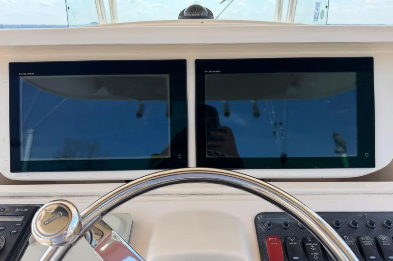  Yacht Photos Pics Helm of 2008 Grady-White Canyon 336 with dual Furuno displays and steering wheel.