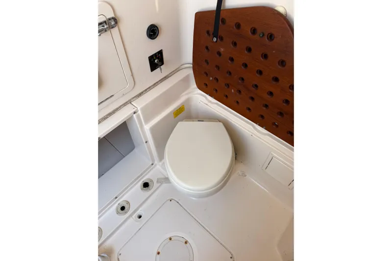  Yacht Photos Pics 2008 Grady-White Canyon 336 boat interior with toilet and wooden panel.