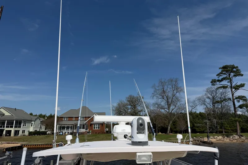  Yacht Photos Pics 2008 Grady-White Canyon 336 boat docked near waterfront homes under clear blue sky.