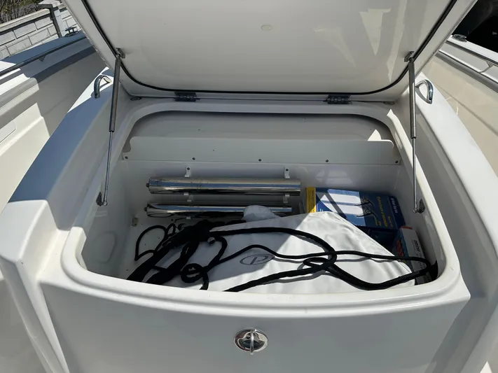  Yacht Photos Pics Open storage compartment on 2020 Pursuit S368 boat with various items inside.