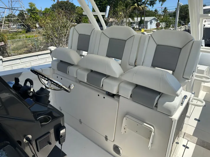  Yacht Photos Pics 2020 Pursuit S368 boat helm with cushioned seating and steering wheel.