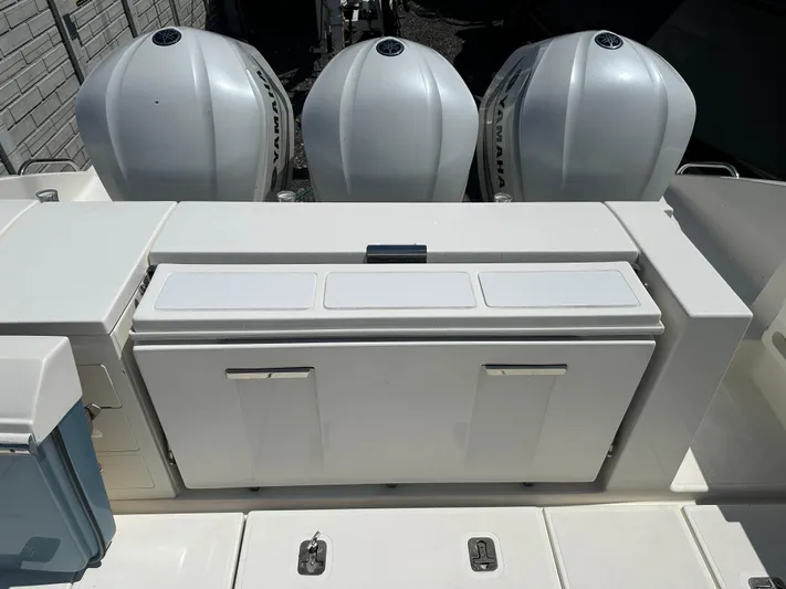  Yacht Photos Pics 2020 Pursuit S368 boat with triple outboard engines and storage compartment.