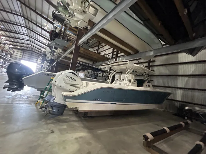  Yacht Photos Pics 2020 Pursuit S368 boat stored indoors with Yamaha engines in a warehouse.