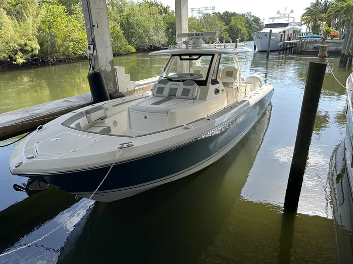  Yacht Photos Pics 2020 Pursuit S368 boat docked in a serene marina setting.