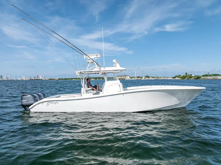  Yacht Photos Pics 2021 Yellowfin 34 boat cruising on open water under a clear blue sky.