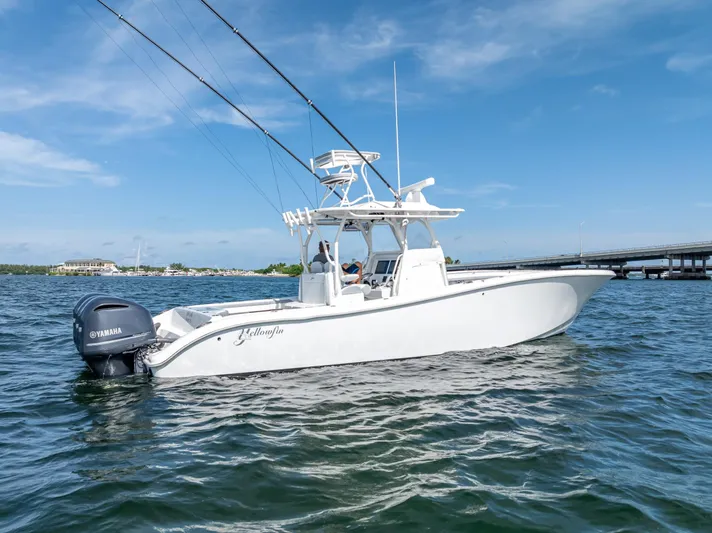  Yacht Photos Pics 2021 Yellowfin 34 boat on water with Yamaha engine, clear sky background.